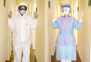 当医院スタッフがゴーグル、帽子、N95 マスク、感染予防着を着用している様子